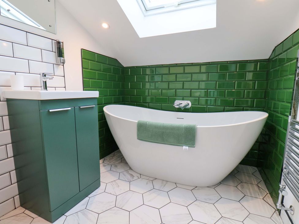 A bathroom with a bathtub and a sink at Sandy Nook in Redcar