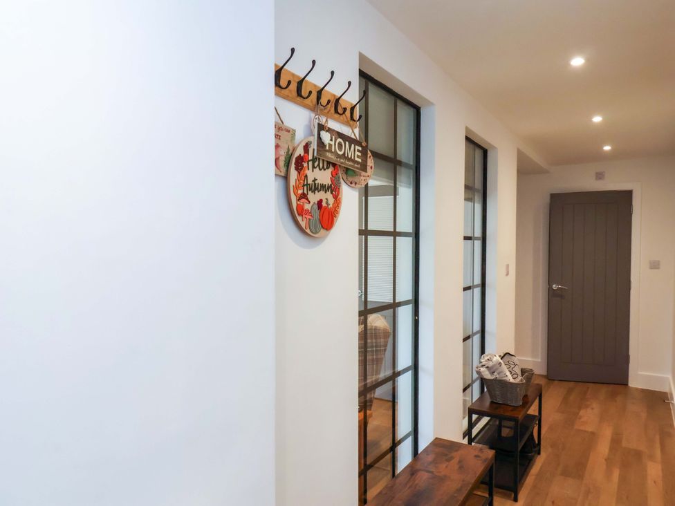 A hallway with coat hooks and a bench at Sandy Nook in Redcar