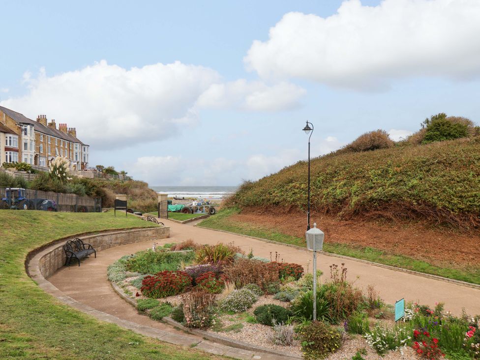 A garden area with flowers and benches at Sandy Nook in Redcar