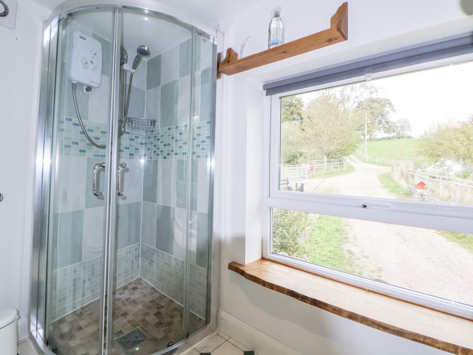 A shower with glass enclosure in a bathroom at The Hayloft in Bodelwyddan