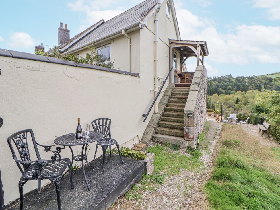 An outdoor seating area with a table and chairs at The Hayloft in Bodelwyddan