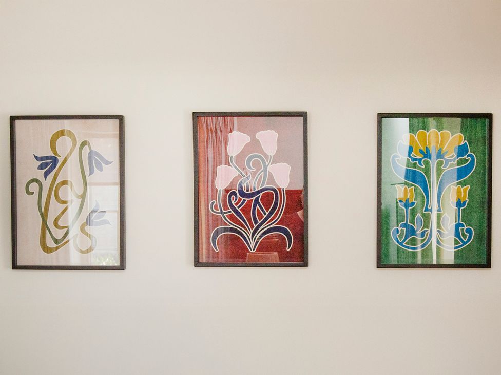 Three framed artworks on a wall at Apartment 2, 86 Dyer Street Cirencester