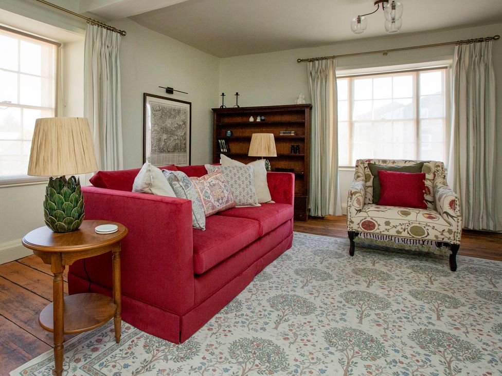A living room with a sofa and armchair at Apartment 2, 86 Dyer Street in Cirencester