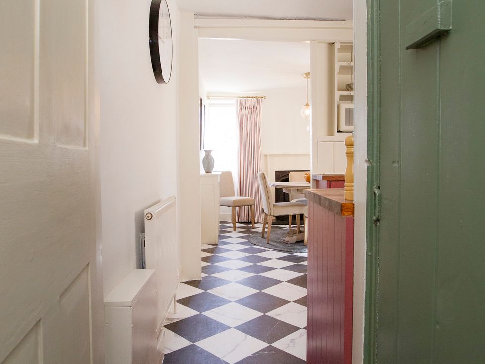 A dining room with a table and chairs at Apartment 2, 86 Dyer Street Cirencester