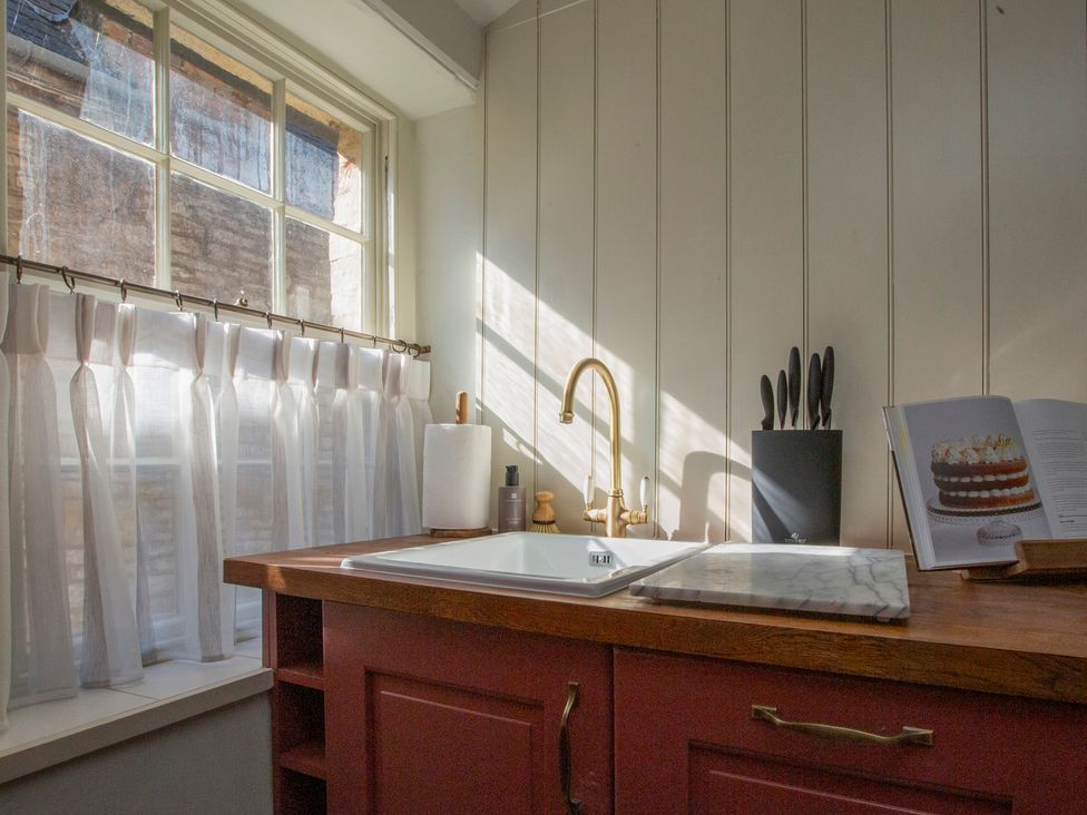 A kitchen with a sink and counter at Apartment 2, 86 Dyer Street Cirencester