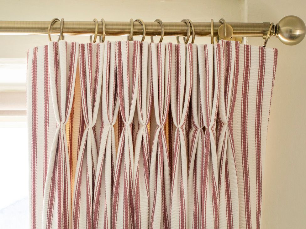 A curtain with vertical stripes in a living room at Apartment 2, 86 Dyer Street in Cirencester