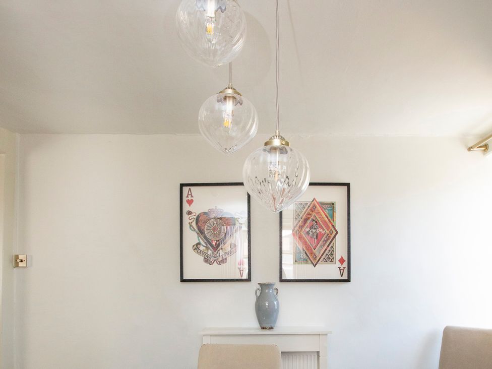 A dining room with wall art and light fixtures at Apartment 2, 86 Dyer Street Cirencester