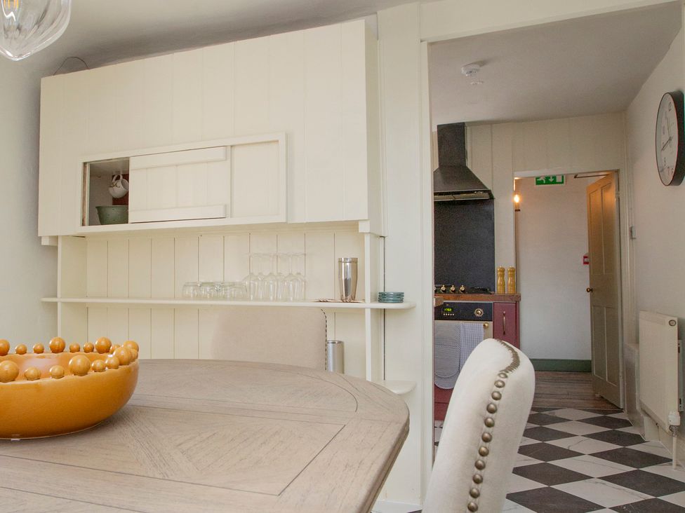 A dining room with a table and chairs at Apartment 2, 86 Dyer Street, Cirencester