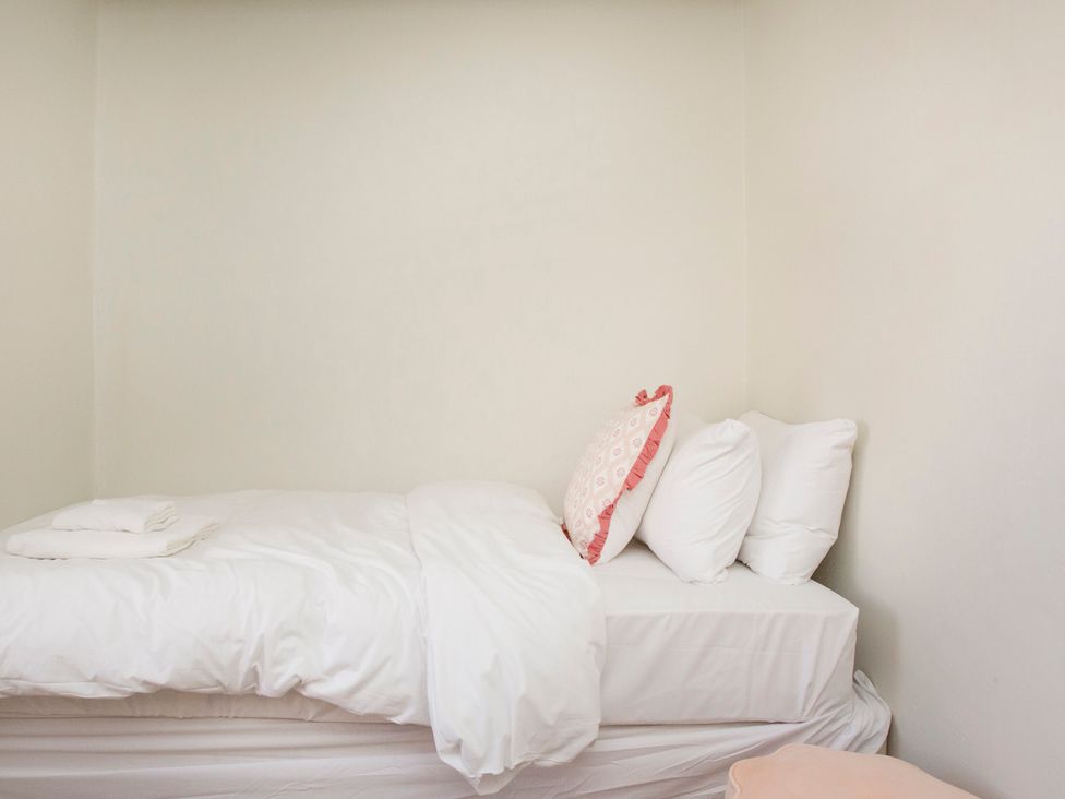 A bedroom with a bed and pillows at Apartment 2, 86 Dyer Street Cirencester