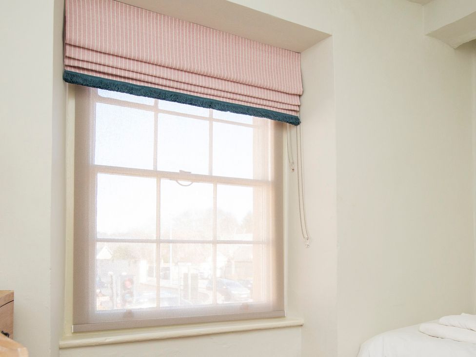 A window with curtains in a bedroom at Apartment 2, 86 Dyer Street Cirencester