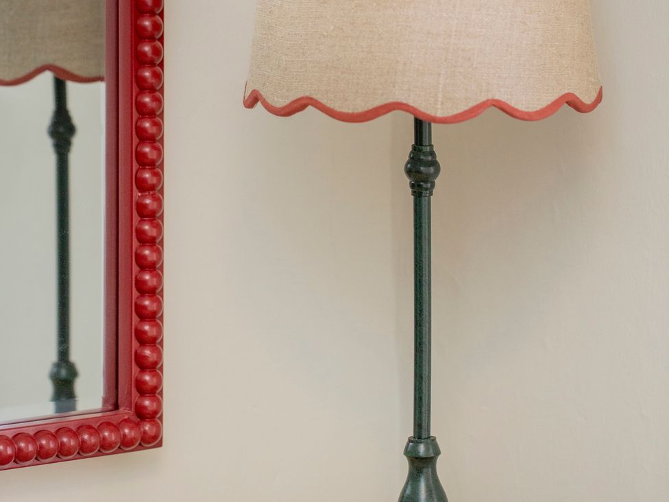 A lamp and mirror on the wall at Apartment 2, 86 Dyer Street Cirencester