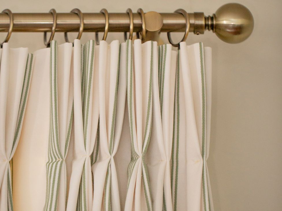 A curtain with green and white stripes in Apartment 2, 86 Dyer Street Cirencester