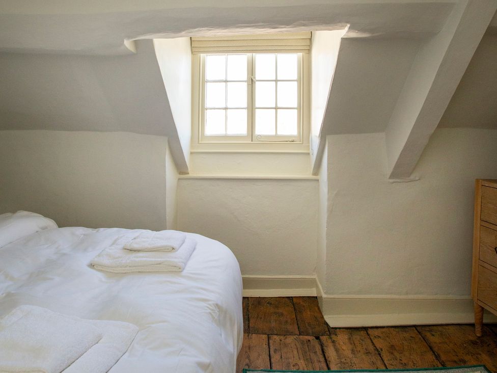 A bedroom with a bed and a window at Apartment 2, 86 Dyer Street Cirencester