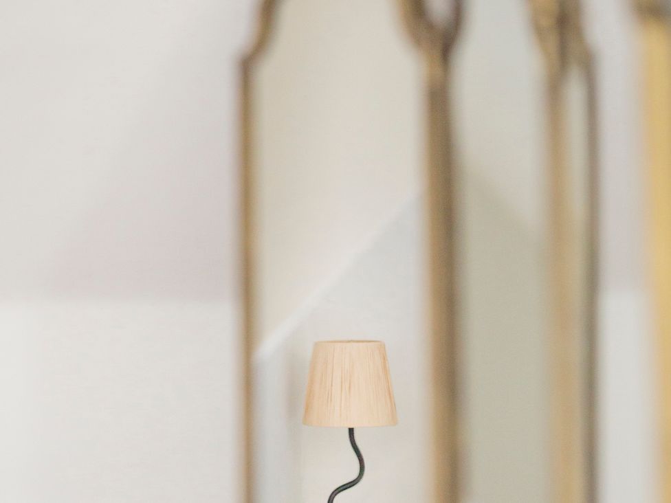 A lamp in front of mirrors at Apartment 2, 86 Dyer Street, Cirencester