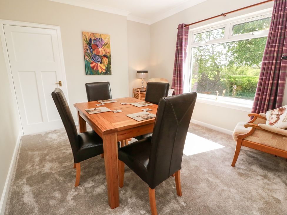 A dining room with a table and chairs at Sundale in Strathaven