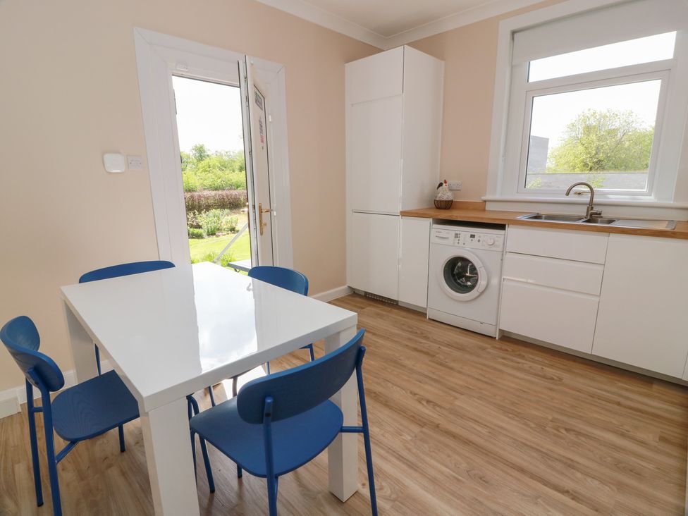 A kitchen with a table and chairs at Sundale in Strathaven