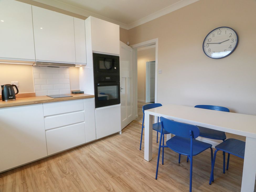 A kitchen with a table and chairs at Sundale in Strathaven