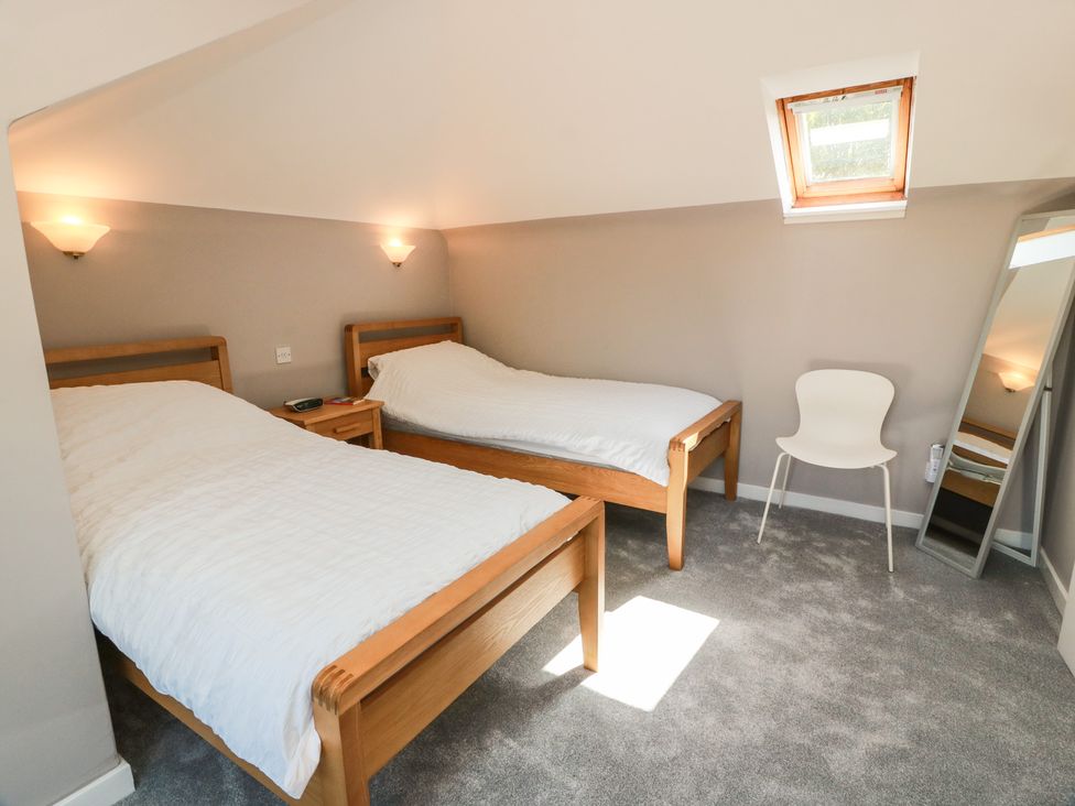 A bedroom with two beds and a window at Sundale in Strathaven