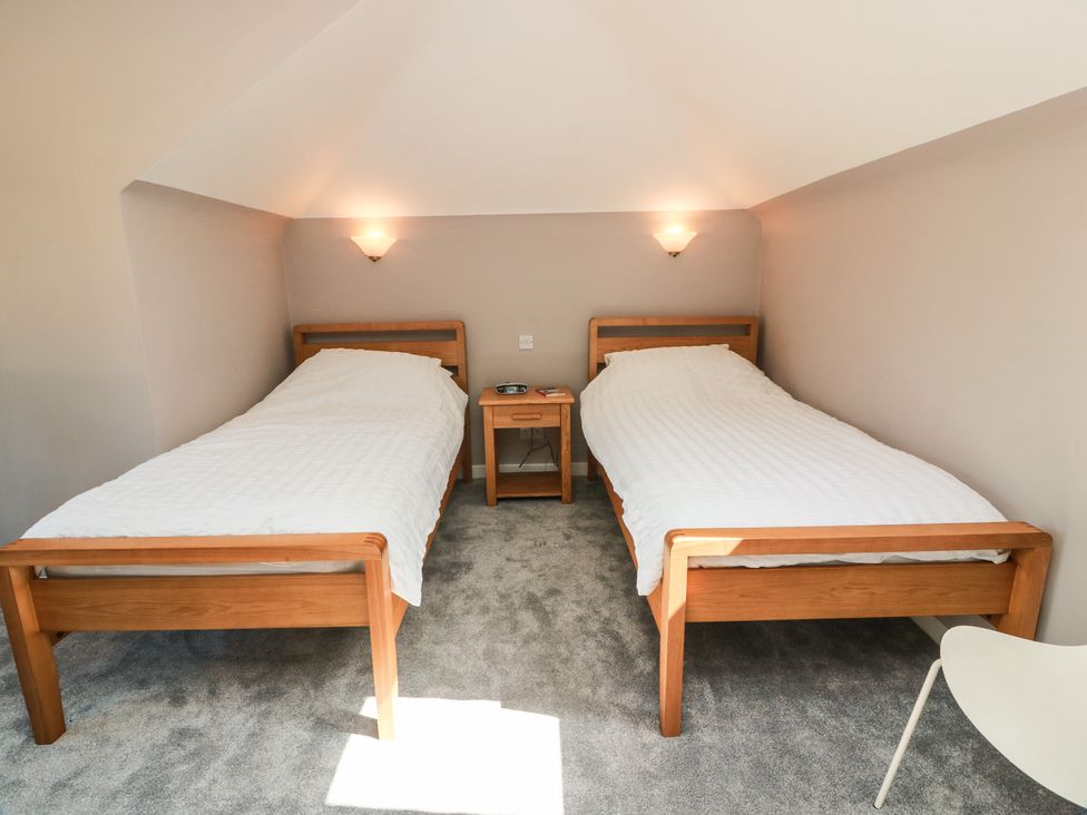 A bedroom with two beds and a nightstand at Sundale in Strathaven