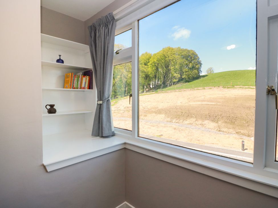A study with a window and shelves filled with books at Sundale in Strathaven
