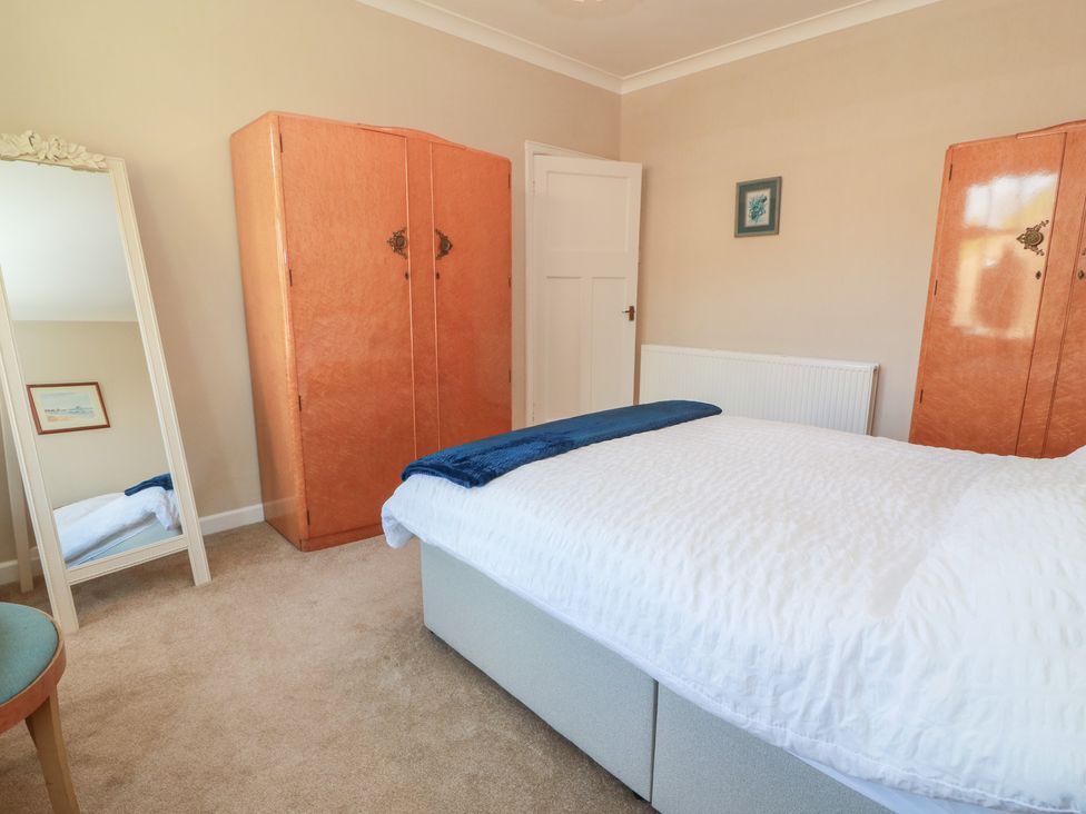 A bedroom with a bed and two wardrobes at Sundale in Strathaven