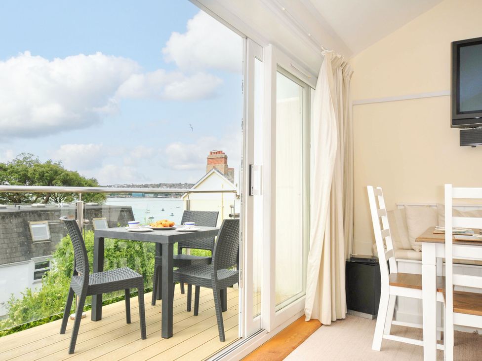 A dining area with outdoor table and chairs at 9 Slipway Cottages Rock