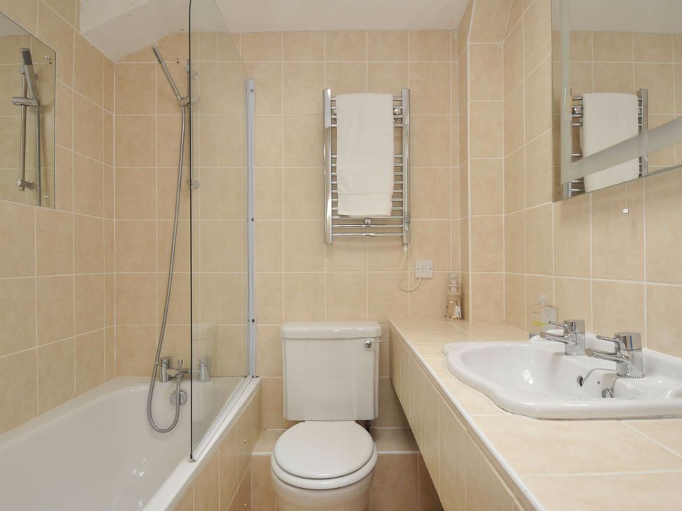 A bathroom with a toilet and sink at 9 Slipway Cottages Rock
