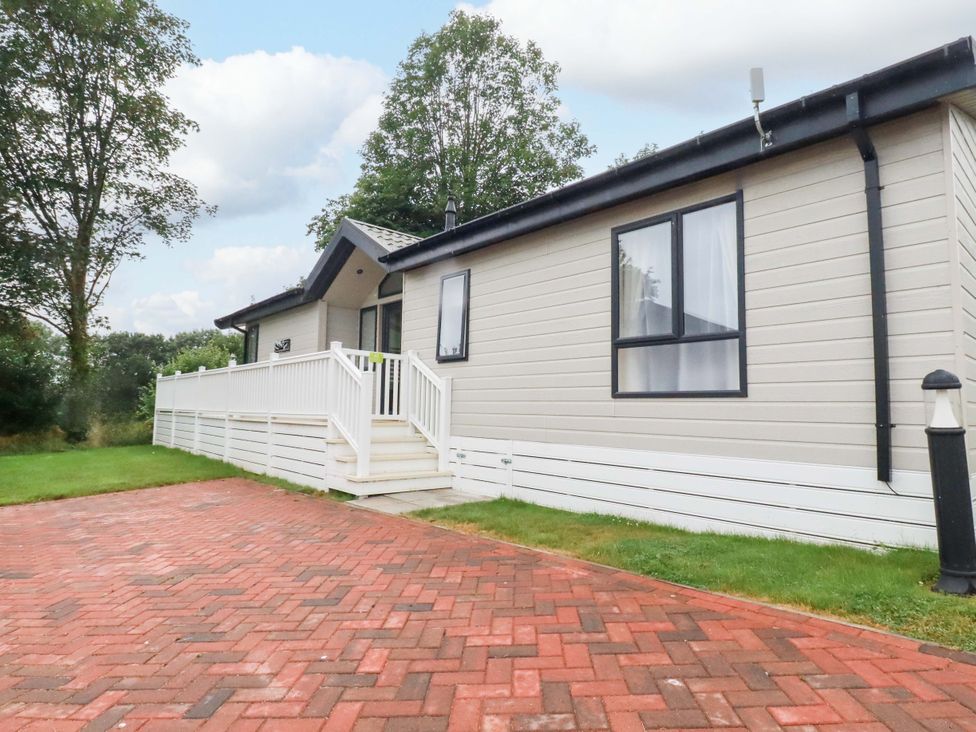An exterior view of a house with a deck and driveway at The Maples 44 St. Austell