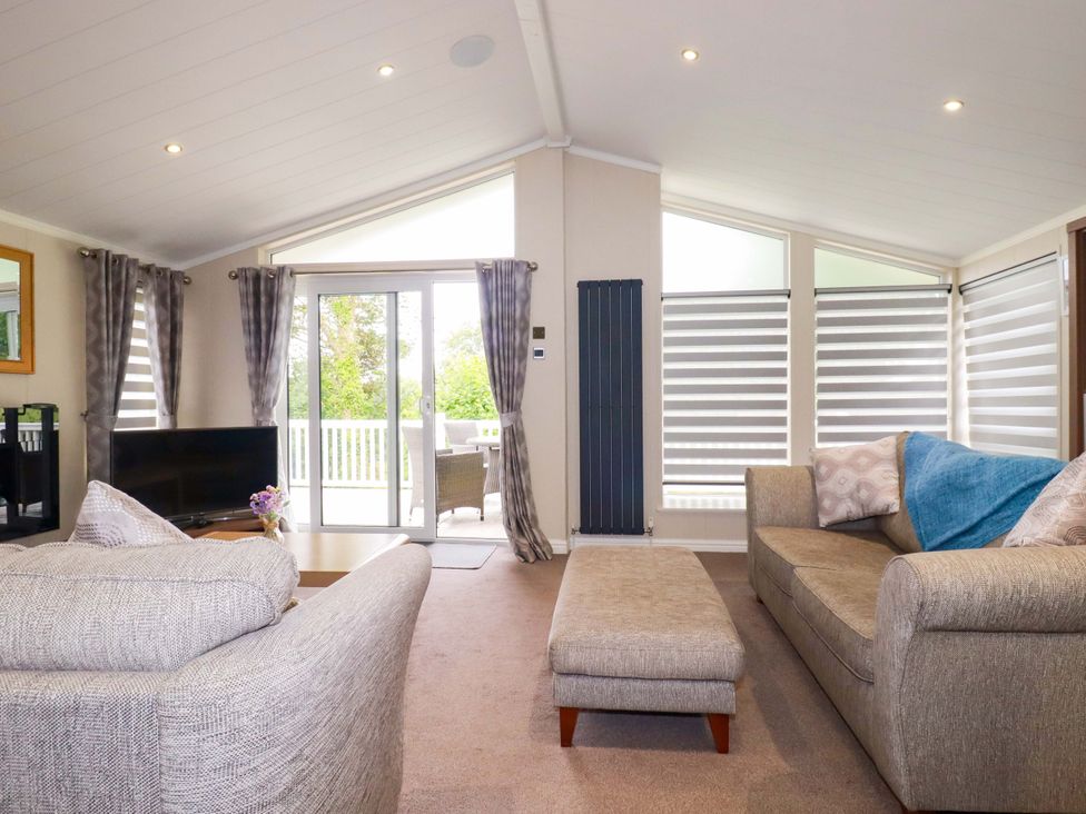 A living room with a sofa and television at The Maples 44 in St. Austell