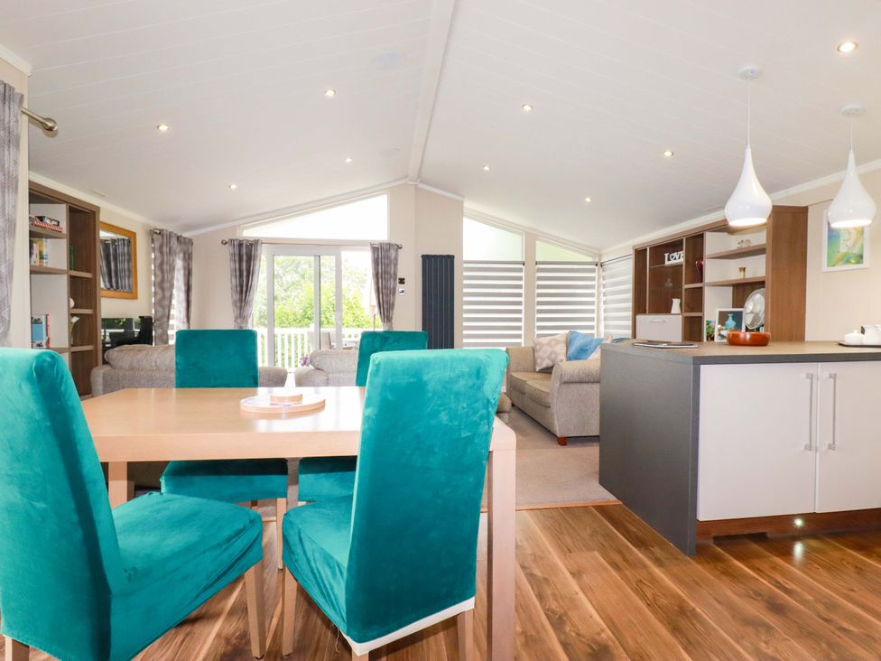 A living room with a dining area and sofa at The Maples 44 in St. Austell