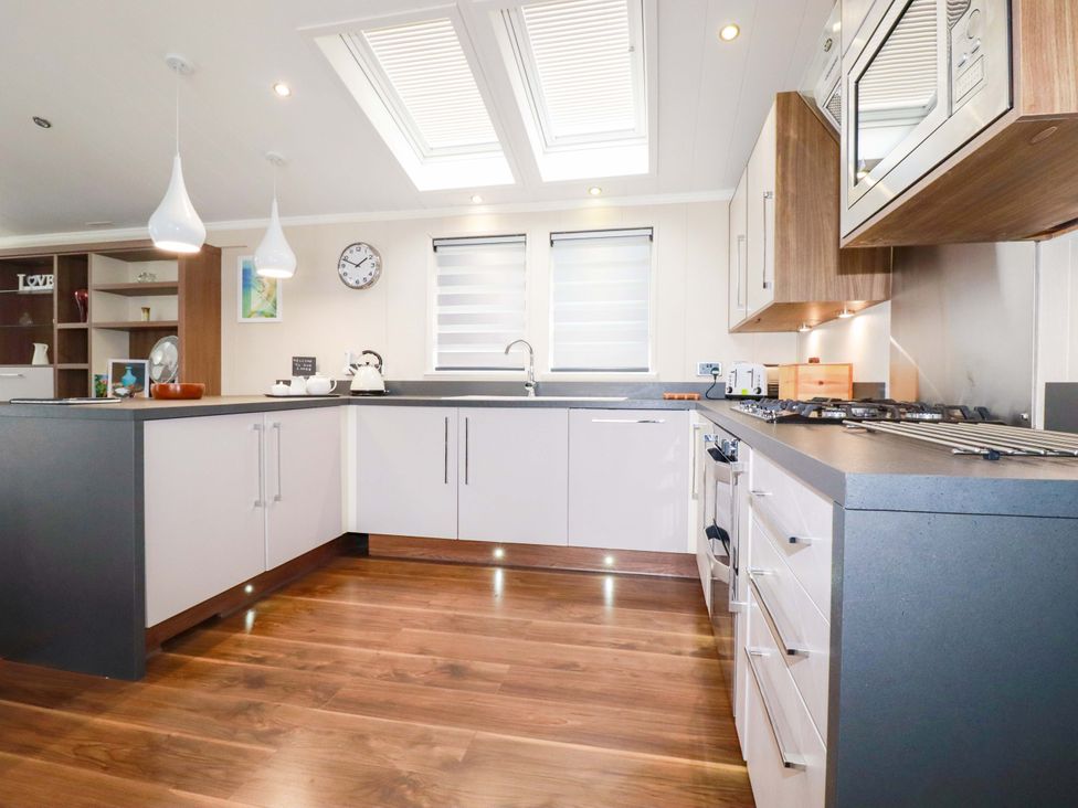 A kitchen with appliances and cabinetry at The Maples 44 St. Austell