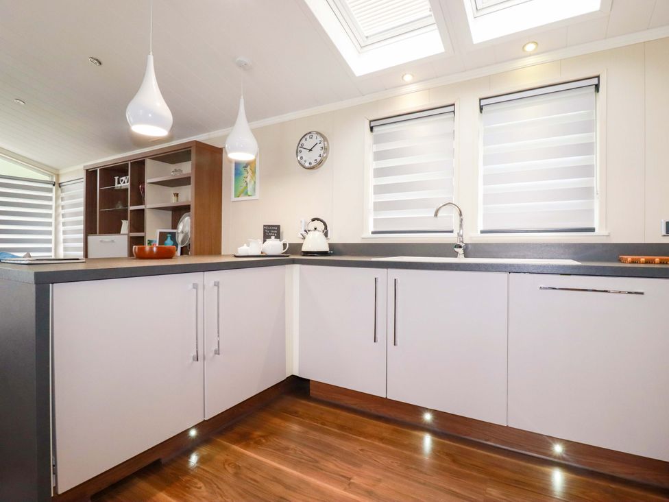 A kitchen with a sink and cabinets at The Maples 44 St. Austell