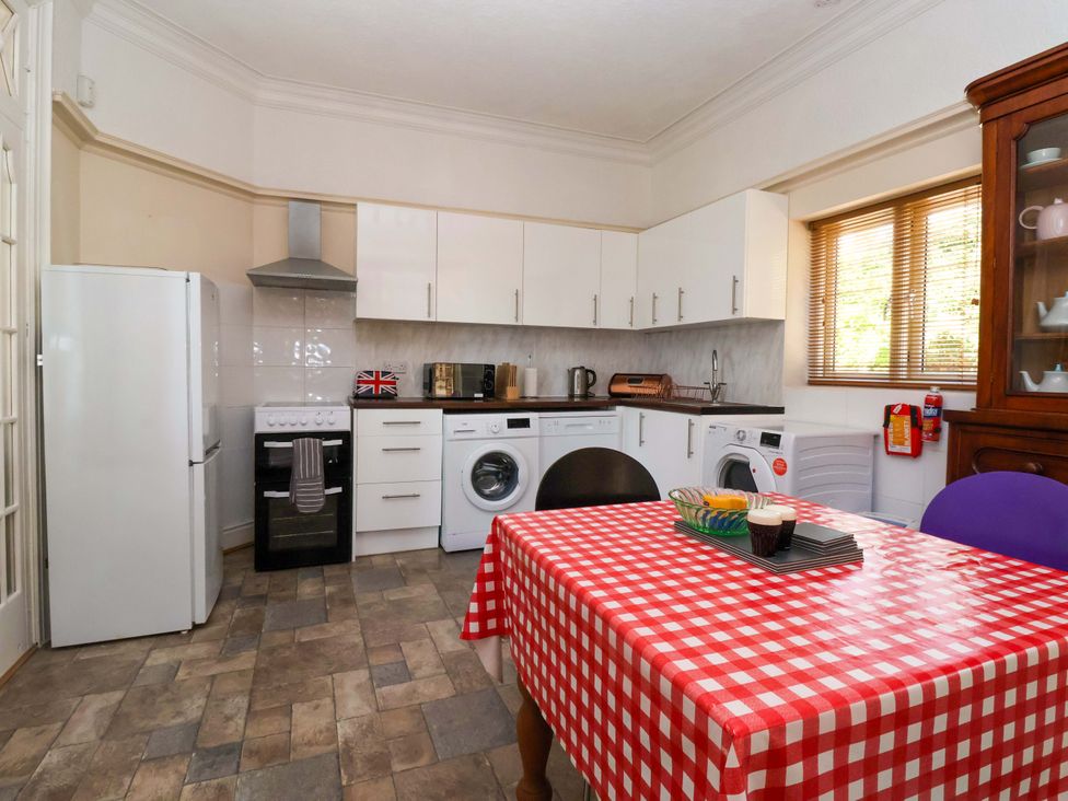 A kitchen with appliances and a dining table at Sandy Shore in Bridlington