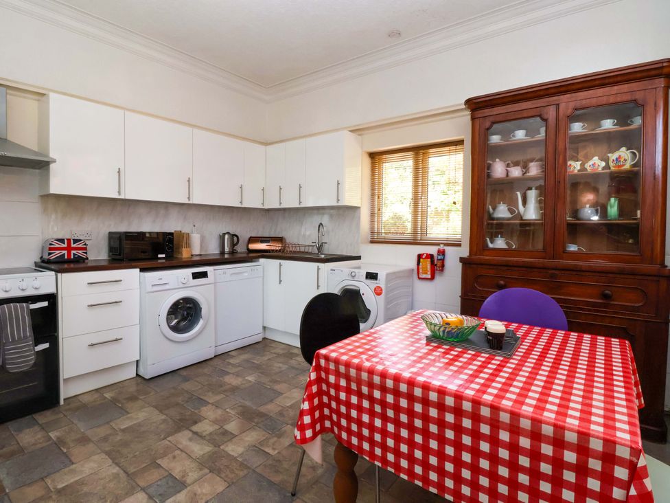 A kitchen with appliances and a dining table at Sandy Shore in Bridlington