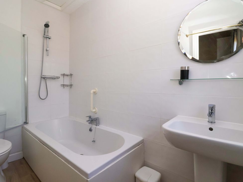 A bathroom with a bathtub and sink at Sandy Shore in Bridlington