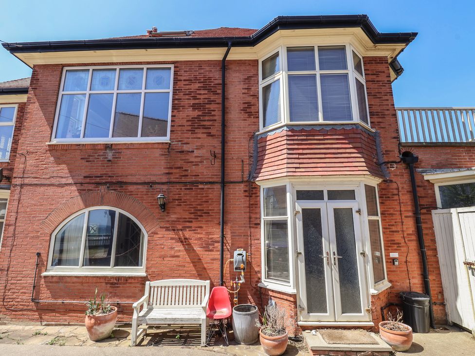 A red brick exterior with windows and a door at Sandy Shore in Bridlington