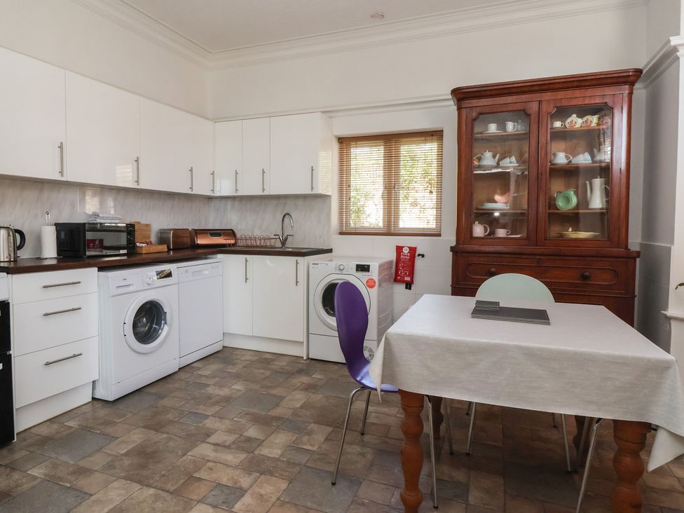 A kitchen with appliances and a table at Sandy Shore in Bridlington