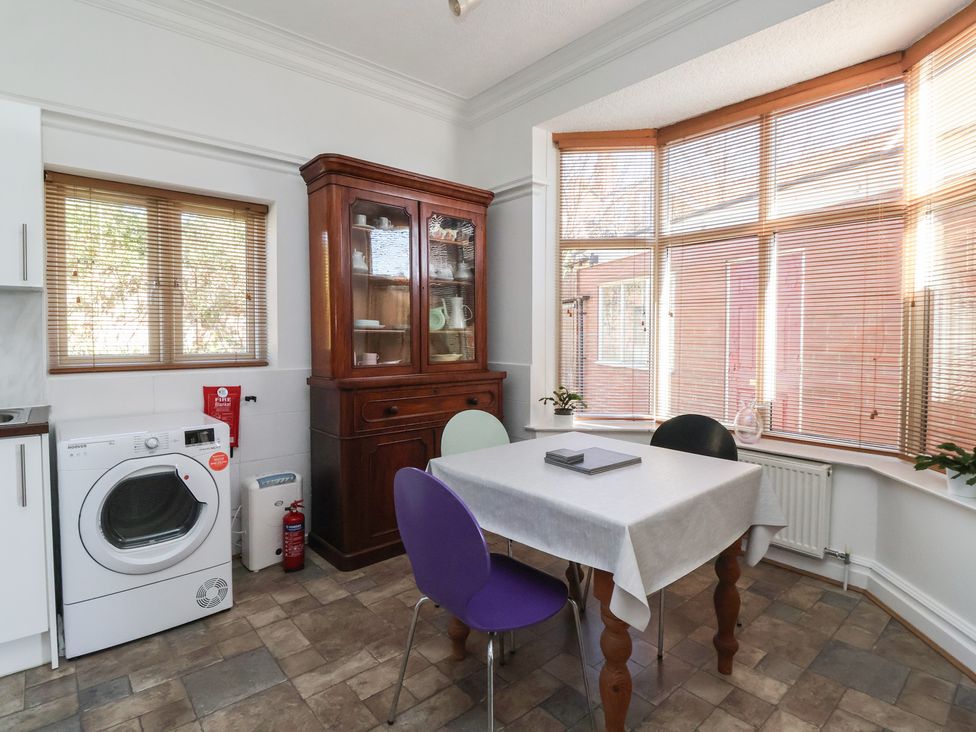 A kitchen with a table and chairs at Sandy Shore in Bridlington