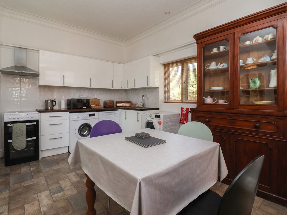 A kitchen with a table and chairs at Sandy Shore in Bridlington
