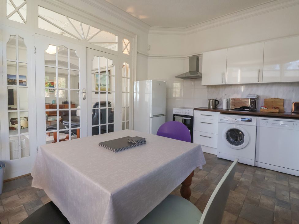 A kitchen with a dining table and appliances at Sandy Shore in Bridlington