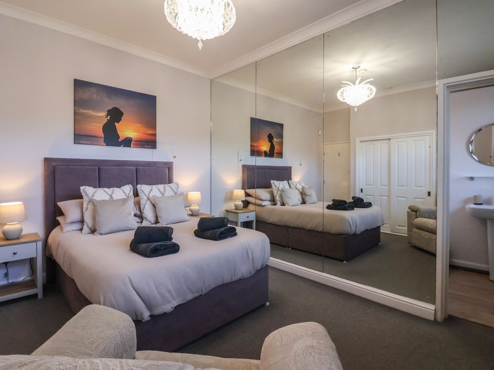 A bedroom with a bed and side tables at Sandy Shore in Bridlington