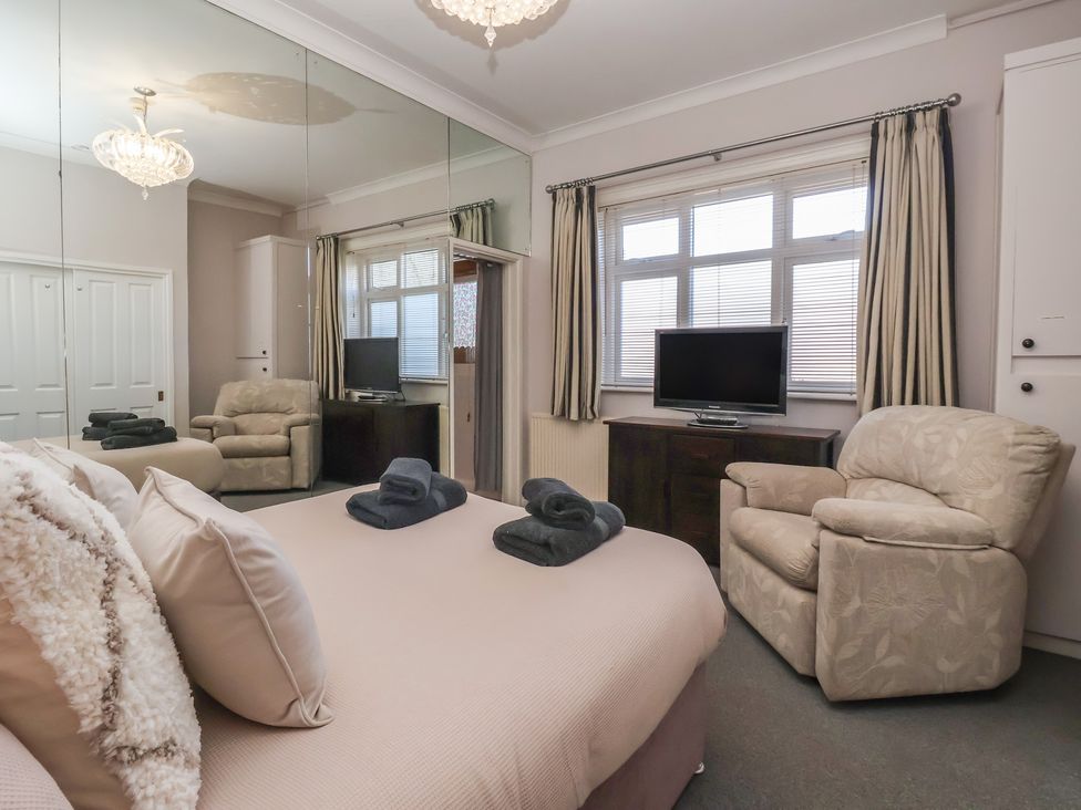 A bedroom with a bed and television at Sandy Shore in Bridlington