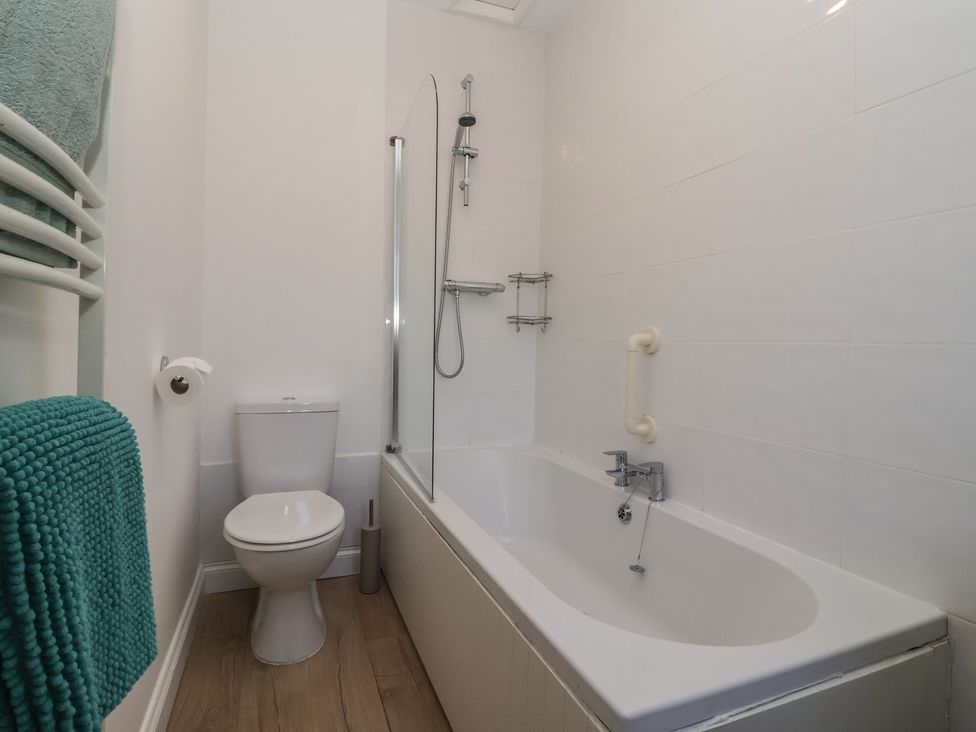 A bathroom with a bathtub and toilet at Sandy Shore in Bridlington