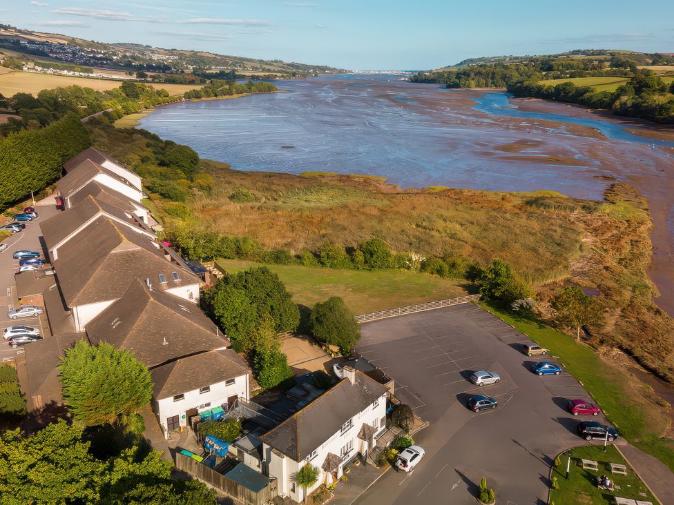 An aerial view of buildings and a river at Osprey in Kingsteignton