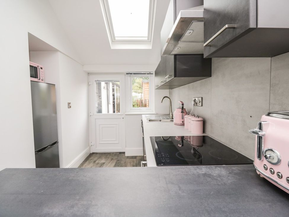 A kitchen with a refrigerator and microwave at Billy's Cottage in Maryport