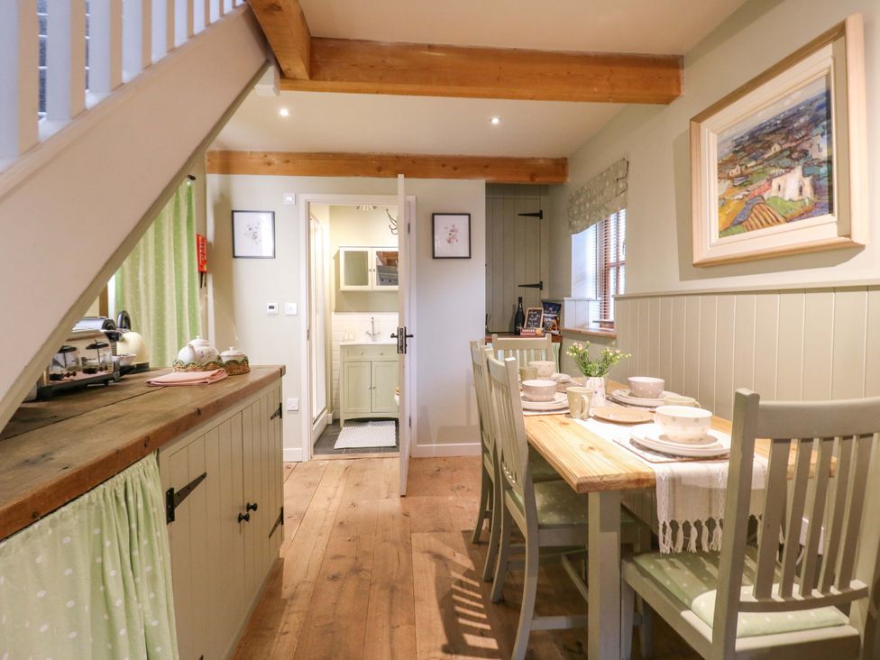 A dining room with a table and chairs at The Hayloft in Charing