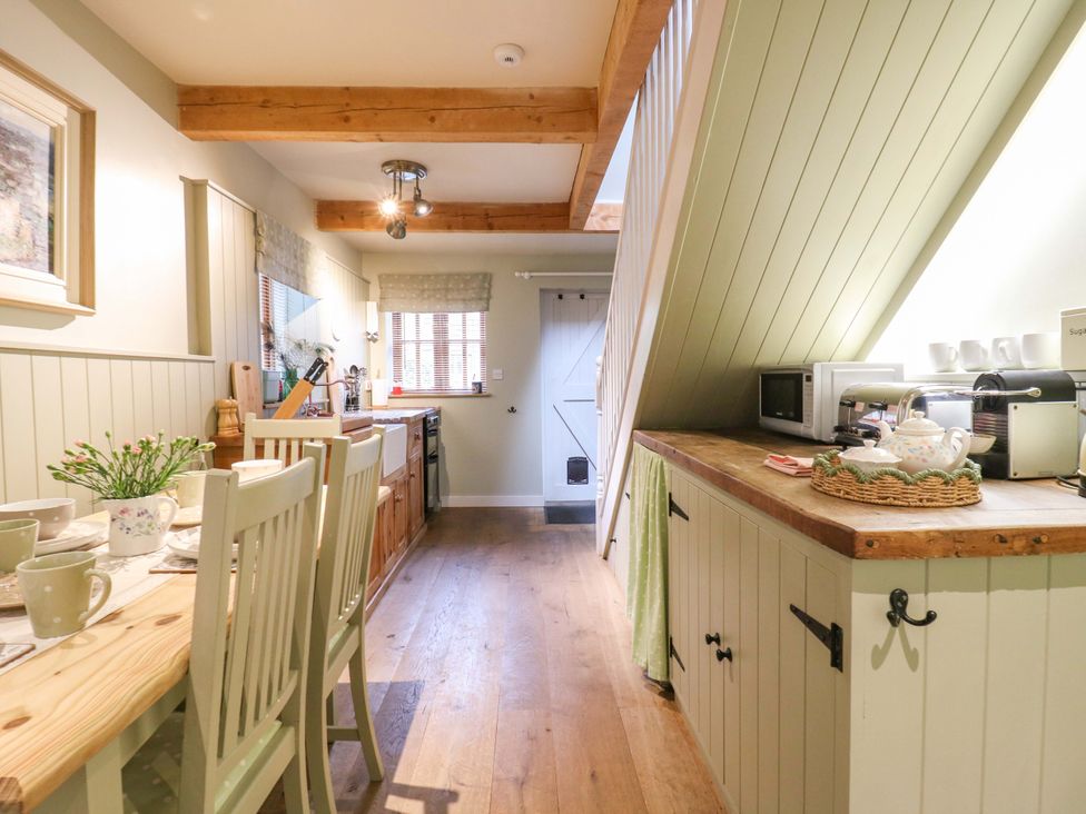A kitchen with table and chairs at The Hayloft in Charing