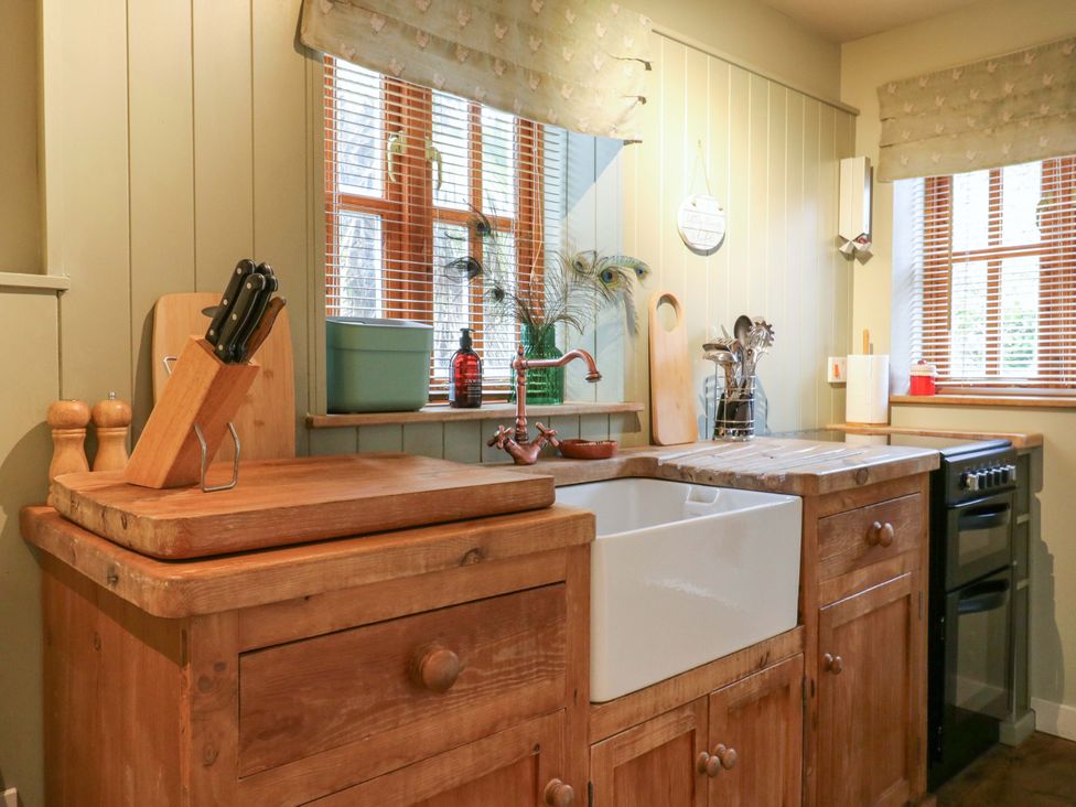 A kitchen with a sink and cutting board at The Hayloft in Charing