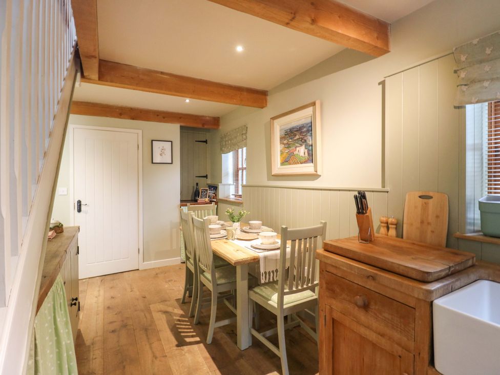 A dining room with a table and chairs at The Hayloft in Charing