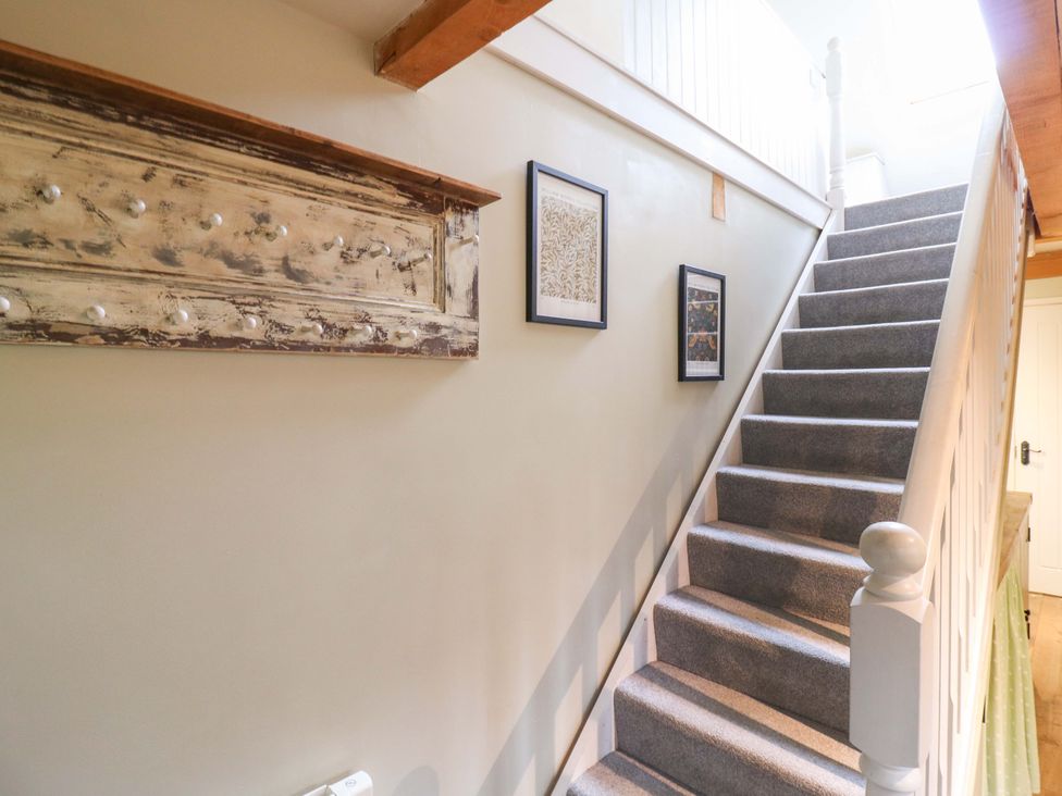 A staircase with decor and walls in The Hayloft in Charing
